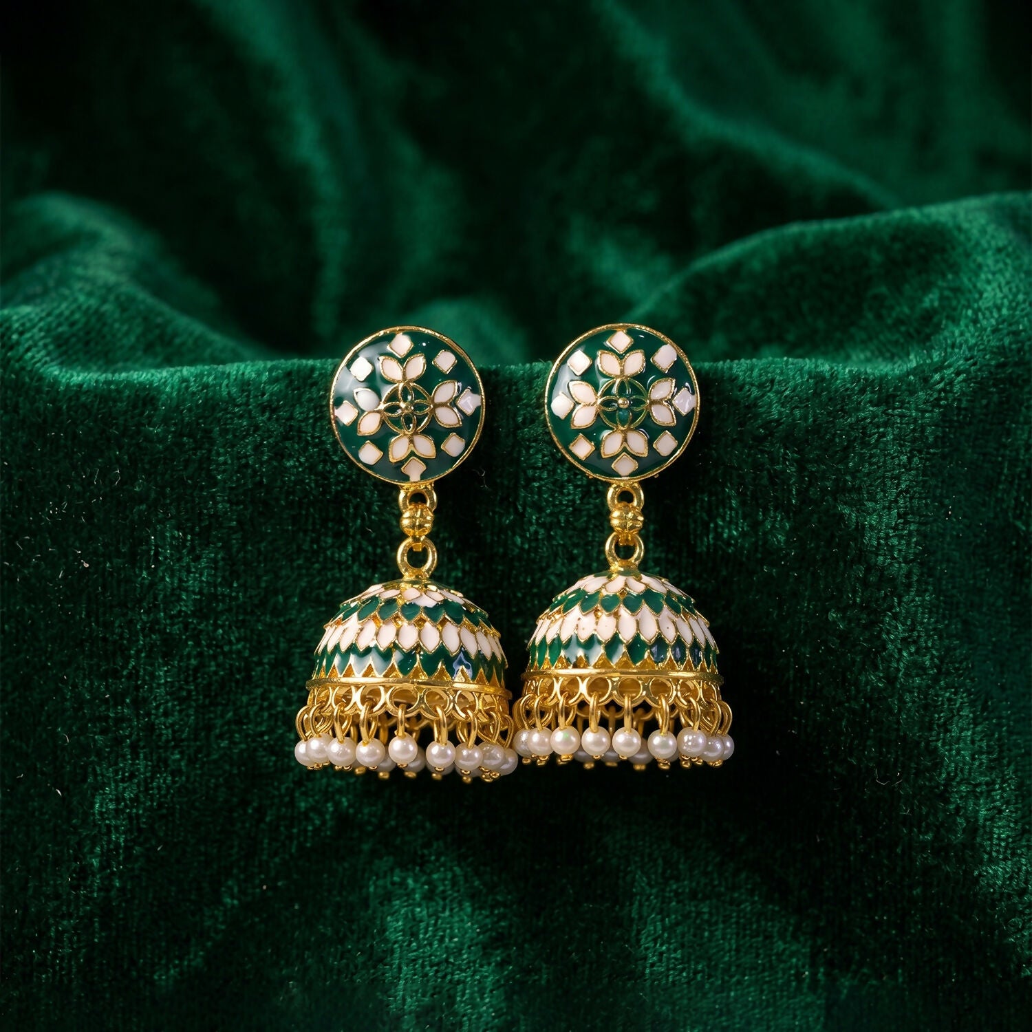 Golden finish and pearl drops on green jhumka earrings
