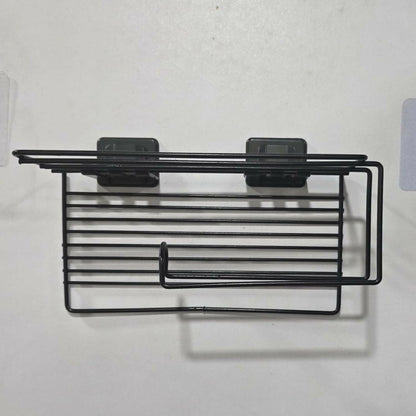 The empty black metal toilet paper holder, showing its wire design and two clear adhesive mounting pads.