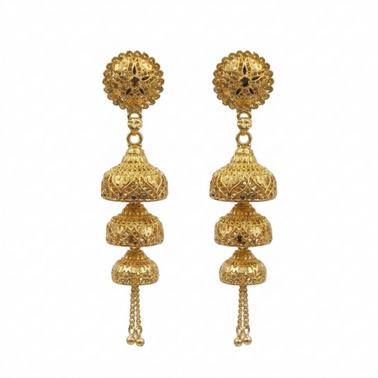 Elegant gold jhumka earrings on a display
