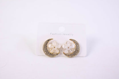 Gold moon and flower crystal stud earrings on white background