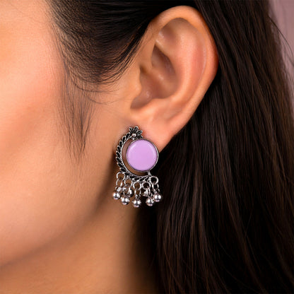 Side angle of oxidized silver earrings with lavender stones