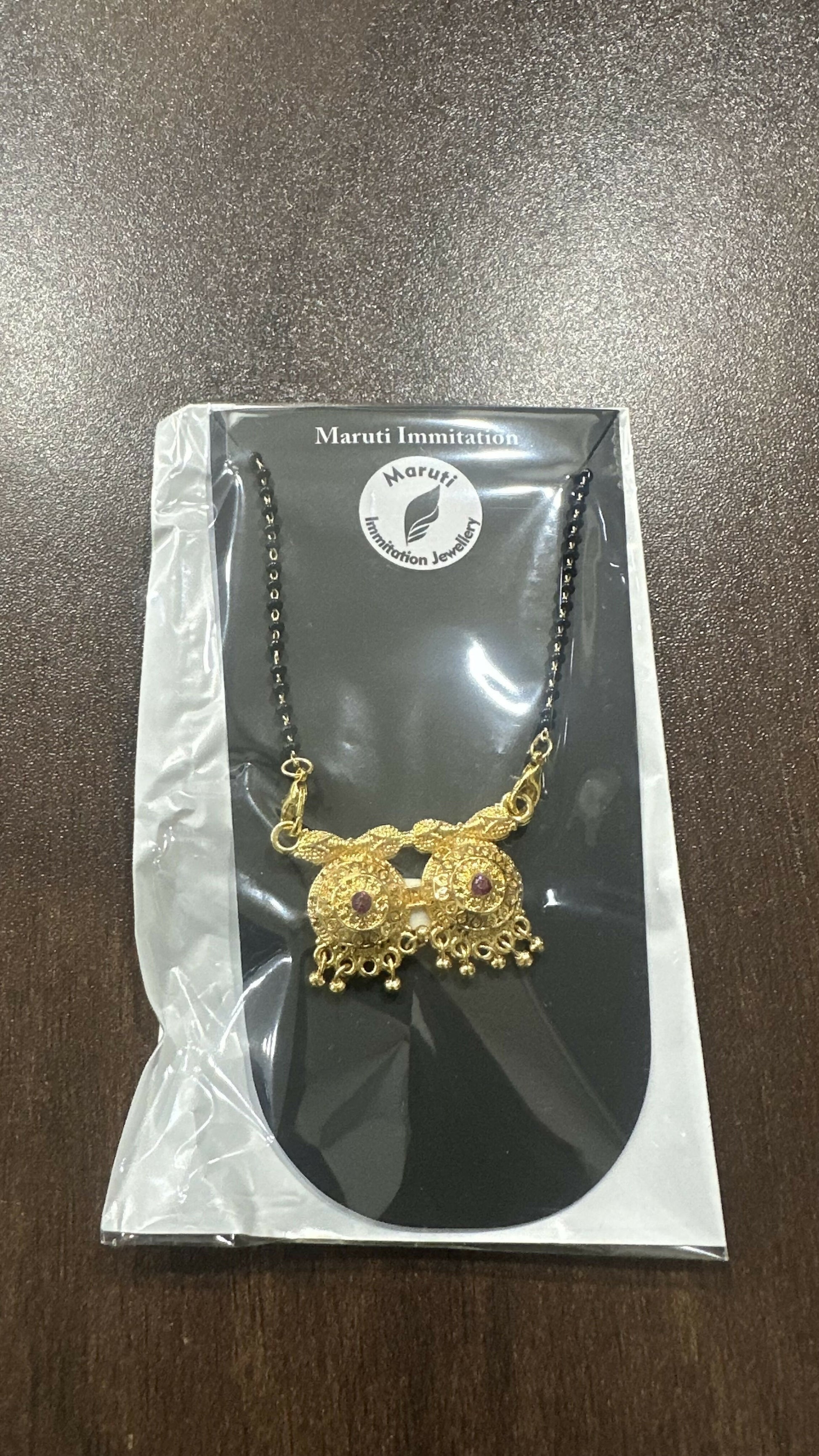 The The Eternal Embrace mangalsutra. The elegant pendant is made of high-quality gold-plated brass.