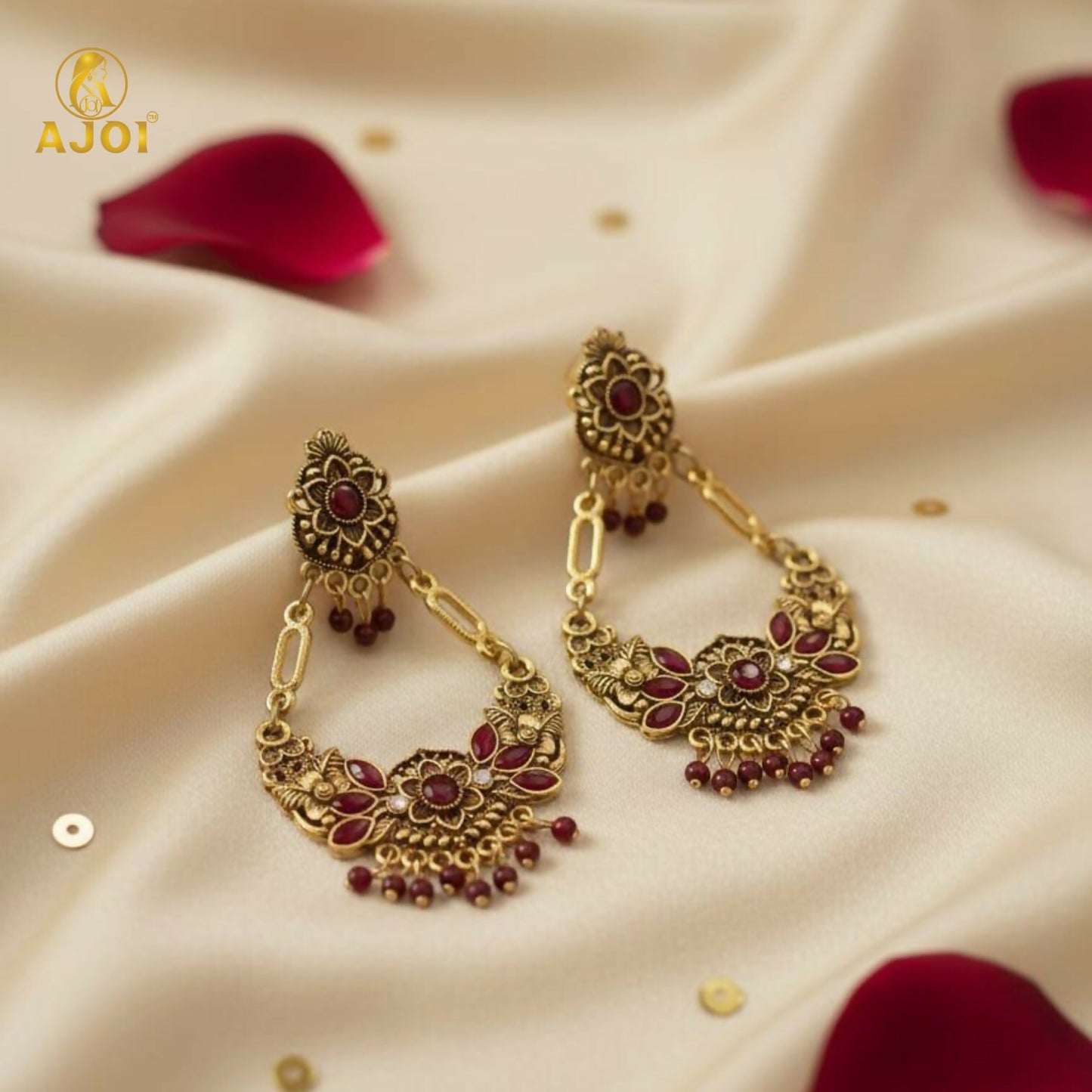 Close-up of maroon floral motifs and stones on chandbali earrings