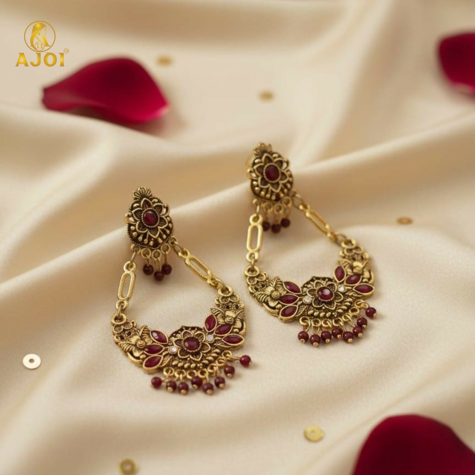 Close-up of maroon floral motifs and stones on chandbali earrings