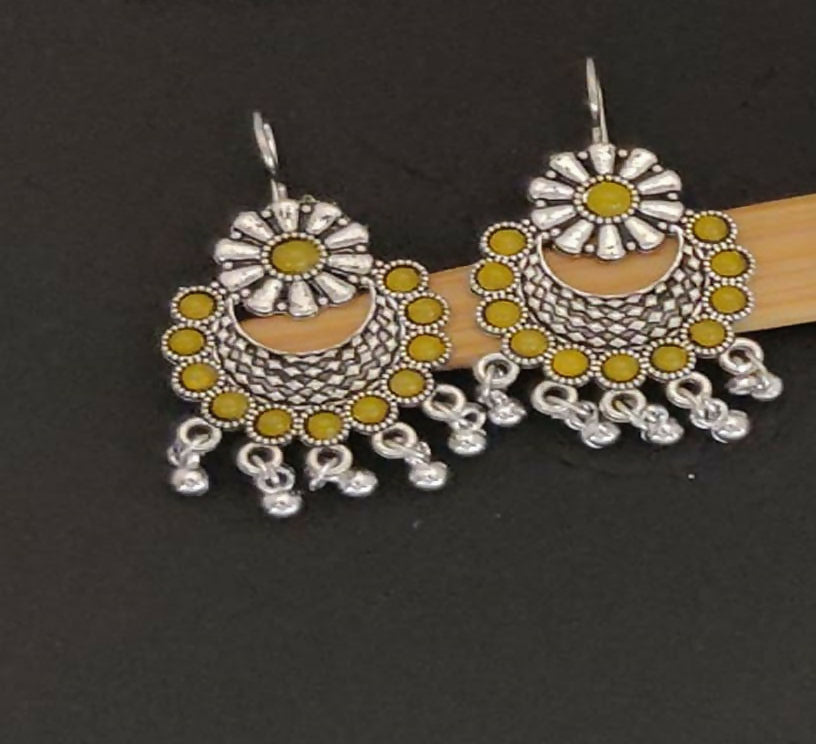 Close-up of oxidised metal jhumka earrings with pearl detailing