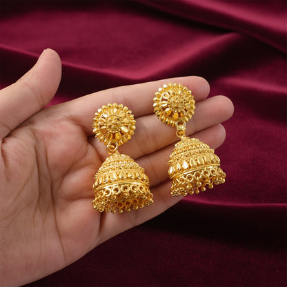 Close-up of detailed traditional design on gold plated jhumka earrings