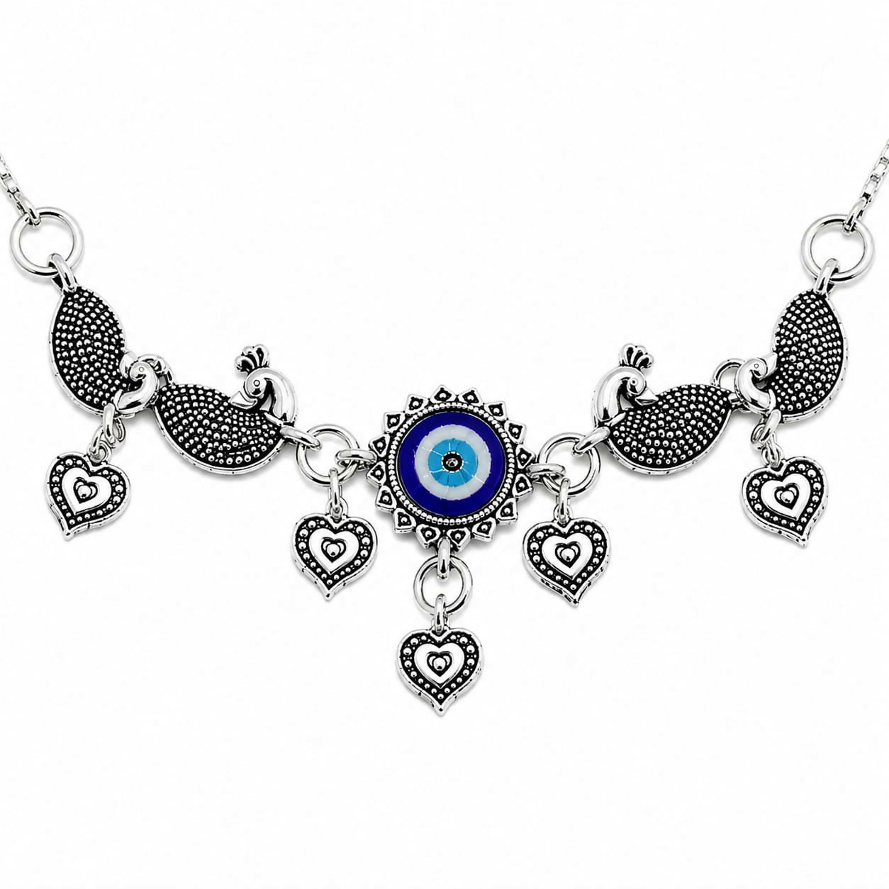 A close-up shows the central evil eye charm, surrounded by peacocks and heart dangles, all in oxidized silver.