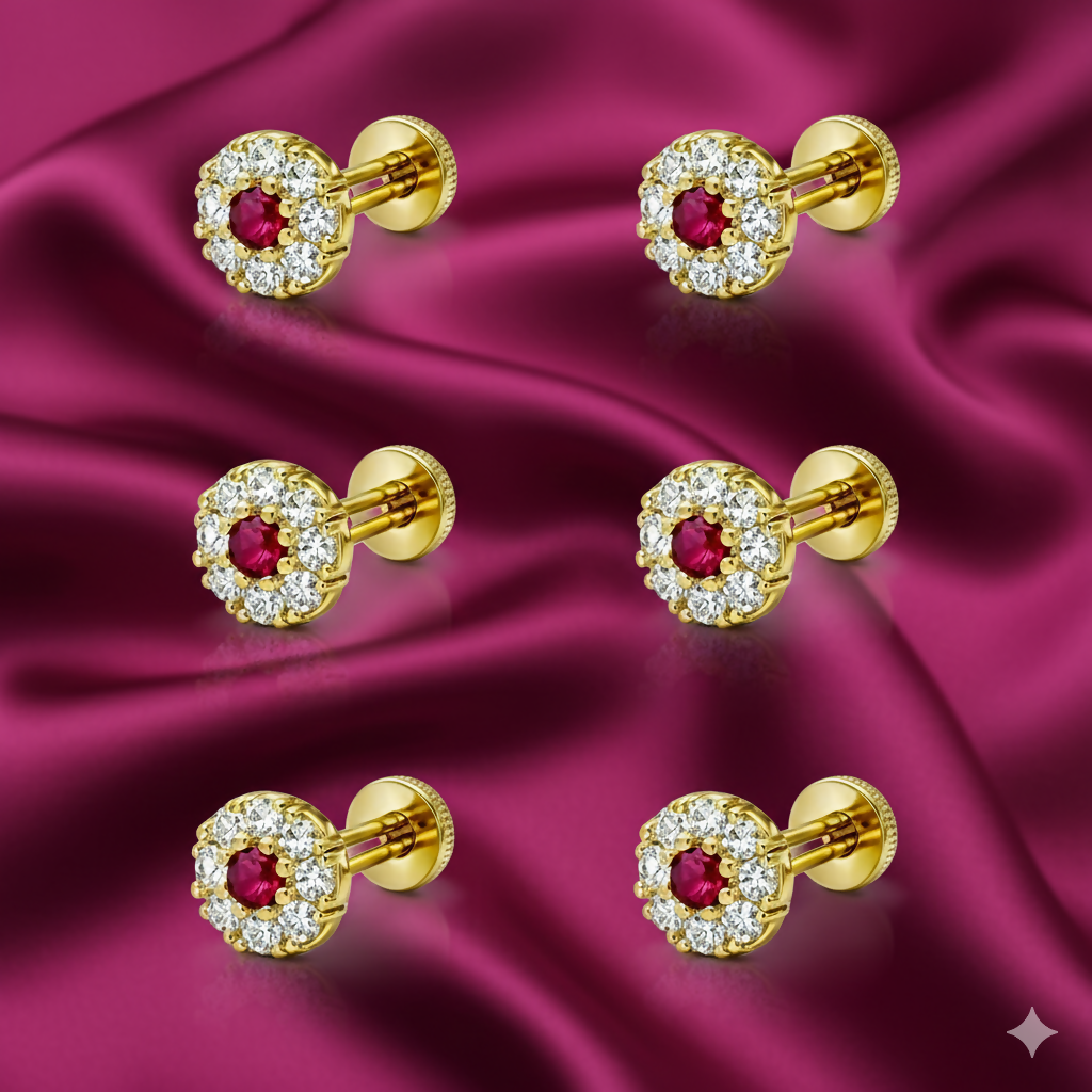 Close-up of gold ruby and diamond halo stud earring pair with intricate floral design