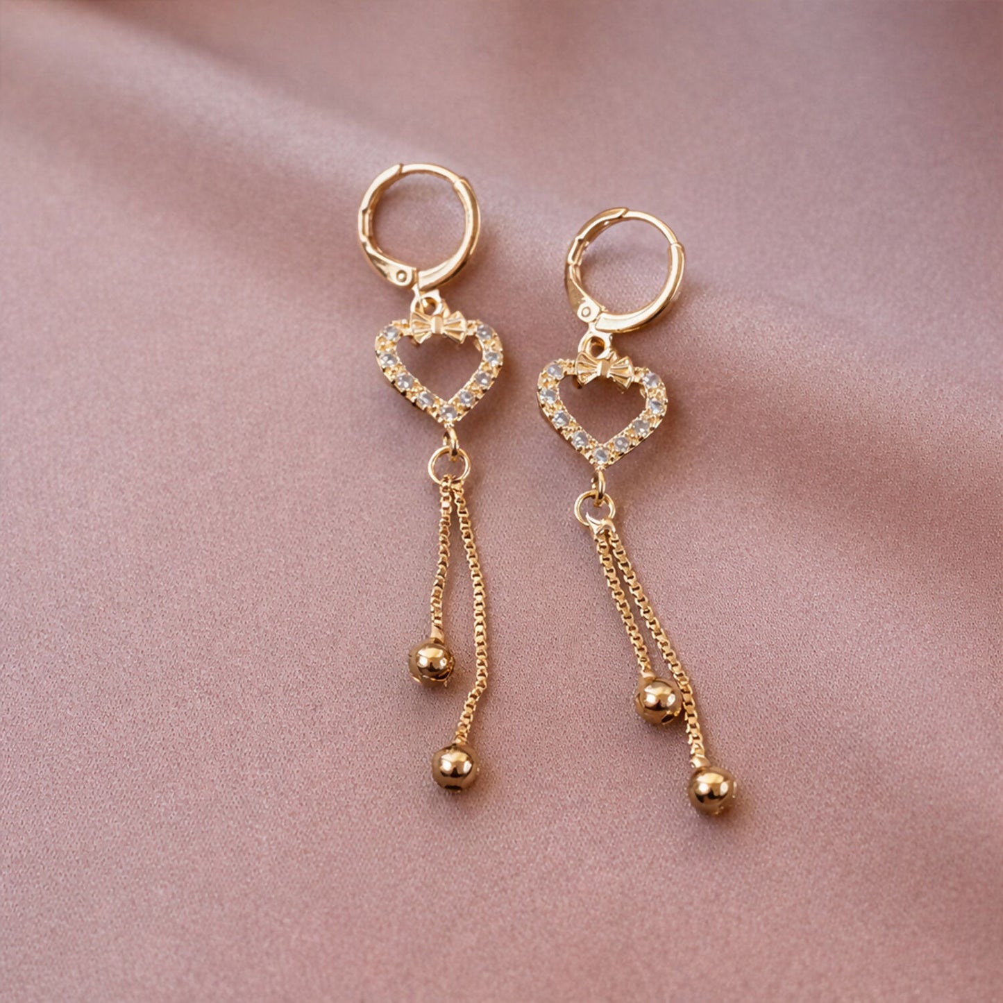 Elegant heart shaped drop earrings showcasing chain tassel details