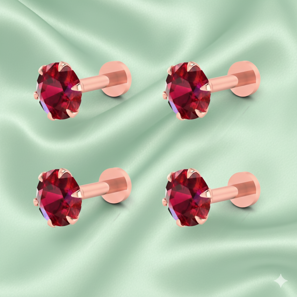 Close-up image of a single rose gold plated nosepin stud featuring a ruby red crystal