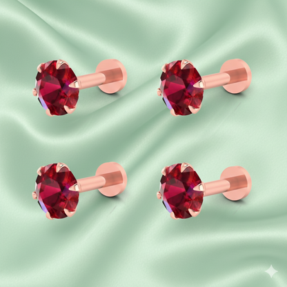 Close-up image of a single rose gold plated nosepin stud featuring a ruby red crystal