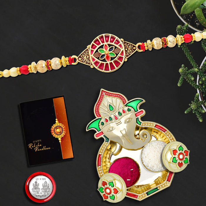 Round Traditional Rakhi With Red Mina Work With Ganesha Pooja Thali Set ,Silver Color Pooja Coin, Roli Chawal & Greeting Card