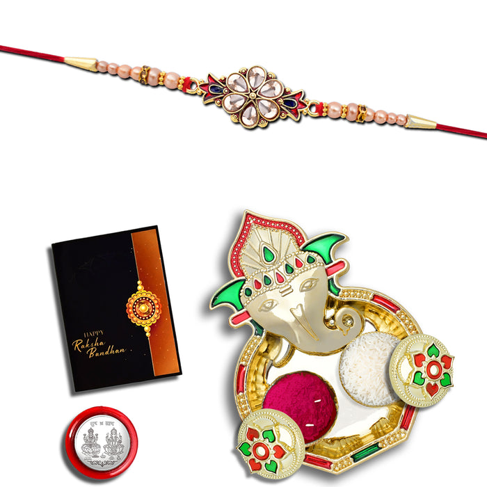 Flower Diamond Rakhi With Red And Blue Mina With Ganesha Pooja Thali Set ,Silver Color Pooja Coin, Roli Chawal & Greeting Card