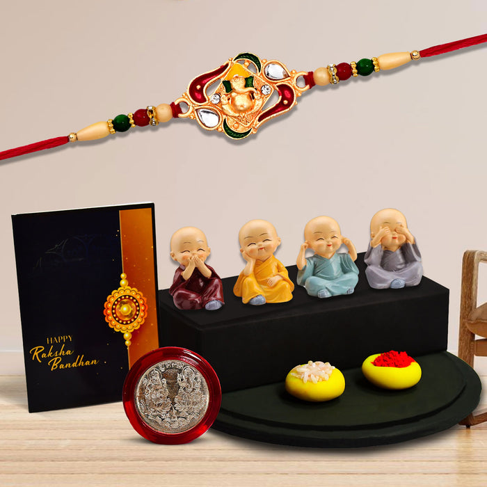 Ganesha With Green And Red Mina Rakhi With Decorative Baby Buddha Gift ,Silver Color Pooja Coin, Roli Chawal & Greeting Card