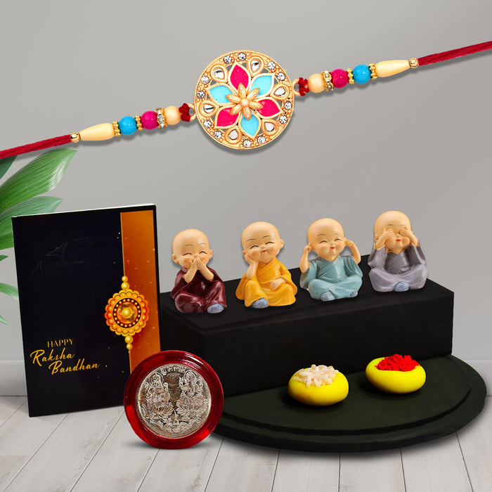Colorful Mina In Round Rakhi With Decorative Baby Buddha Gift ,Silver Color Pooja Coin, Roli Chawal & Greeting Card