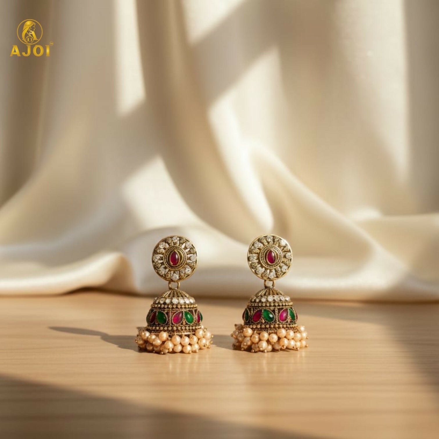 Front view showing detailed dome-shaped jhumka with stones and pearls