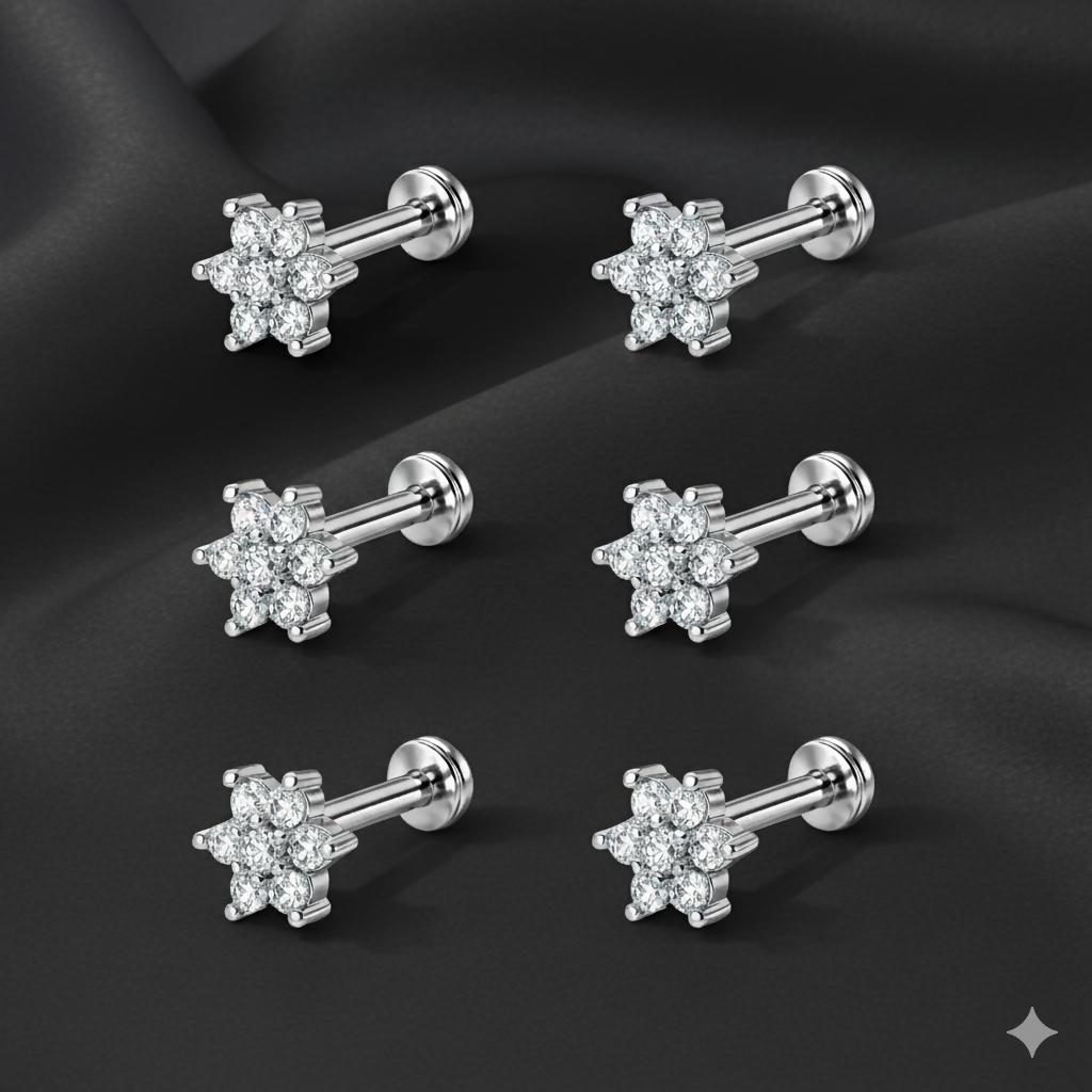 Set of three pairs of silver plated crystal flower stud earrings displayed against a white background