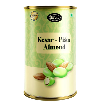 A close-up of the Kesar Pista Almond tin shows its green and gold label with a few almonds and green coated nuts at the base.
