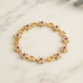 Gold-Tone Flower Link Bracelet with Pink Stones, Crystal Petals and Square Accents