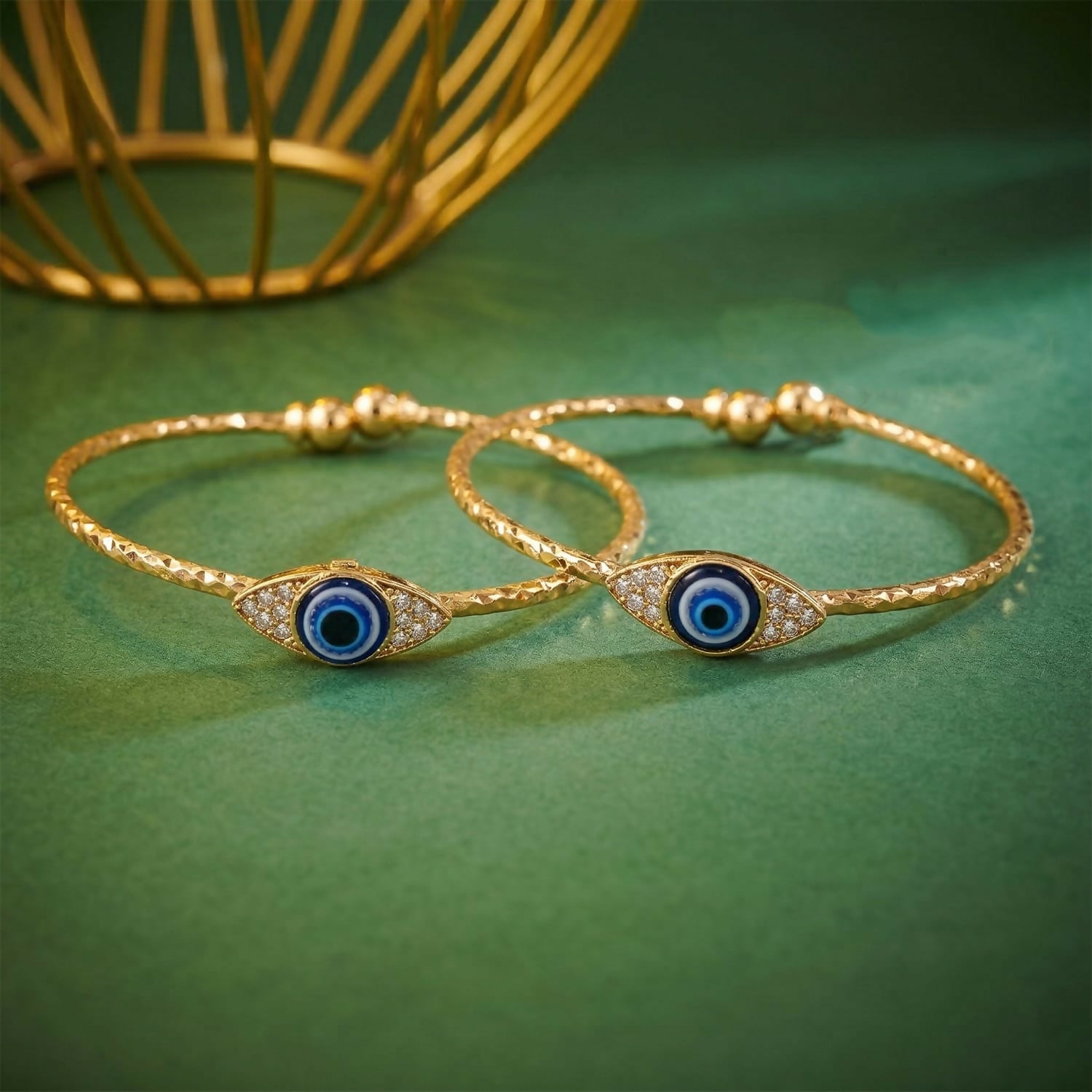 Close-up of gold evil eye bangle showing blue eye and sparkling stones