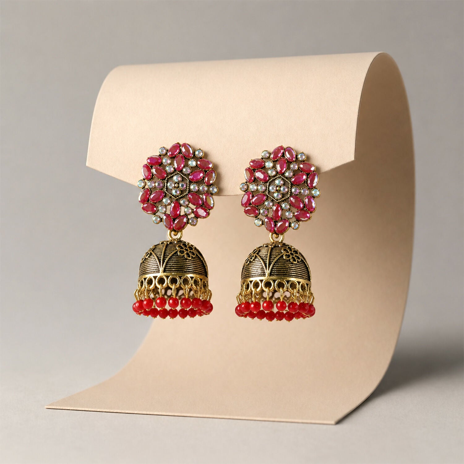 Golden jhumka earrings with red bead and floral design, front view