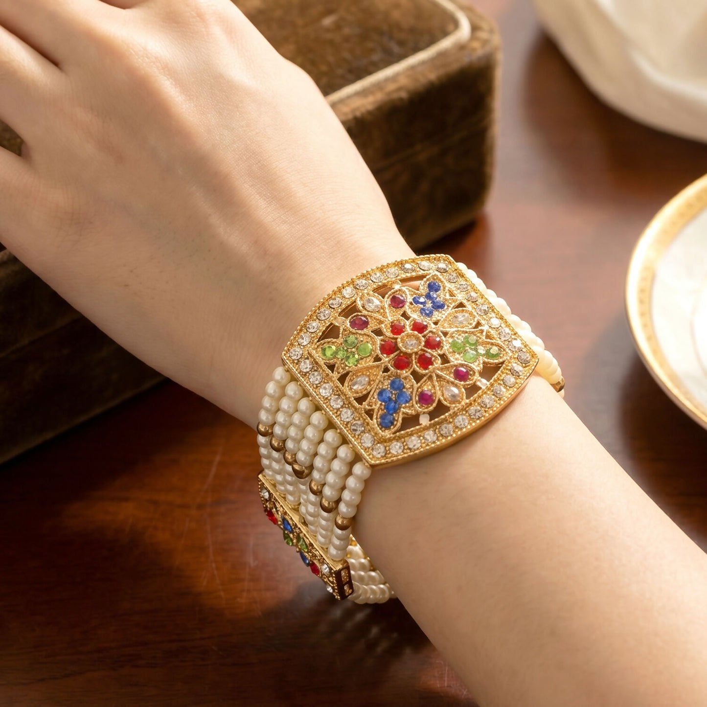 Close-up of gold detailing on pearl bracelet