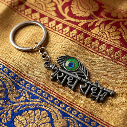 Radhe Radhe Metal Keychain with Peacock Feather Design – Divine Copper Finish (Mix Color) (1 Pc)