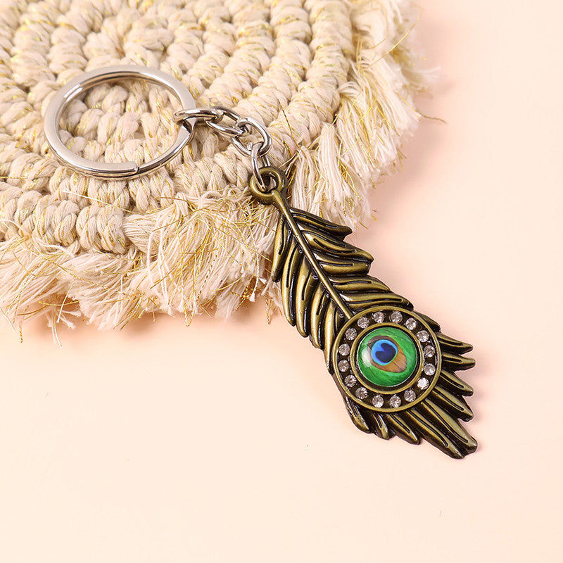 Krishna Mor Pankh Metal Keychain – Peacock Feather with Stone Work
