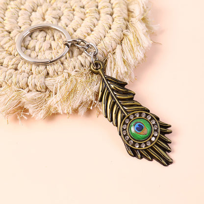 Krishna Mor Pankh Metal Keychain – Peacock Feather with Stone Work