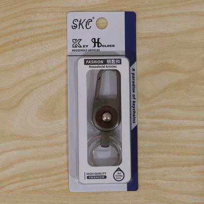 Compact metal key holder featuring locking carabiner clip in outdoor setting