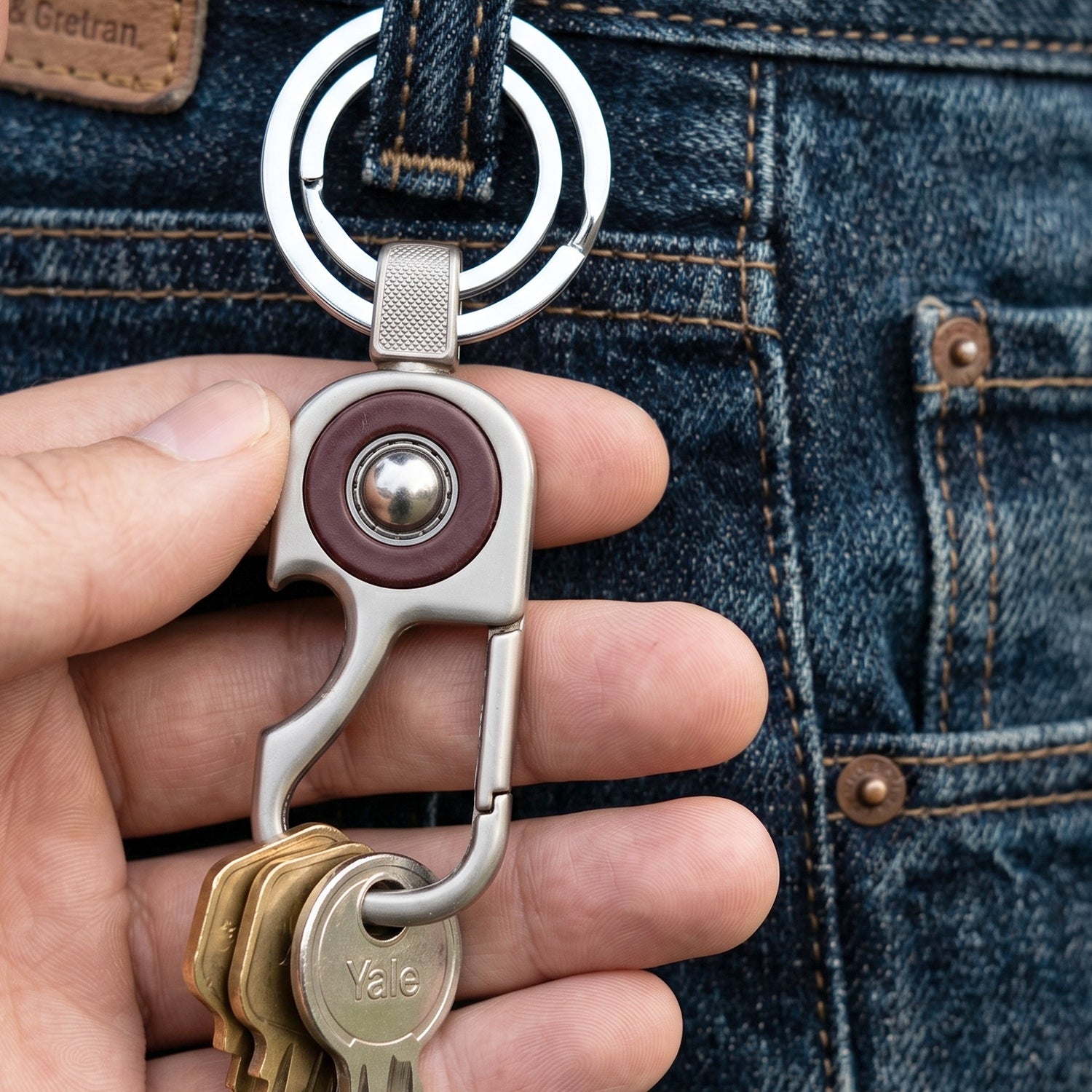 Portable metal key holder with dual rings for organizing multiple keys.