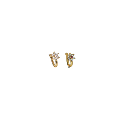 Close-up of gold-plated traditional floral nose ring with ruby-colored stone