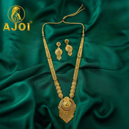 Elegant long necklace set reflecting light in a rich emerald backdrop