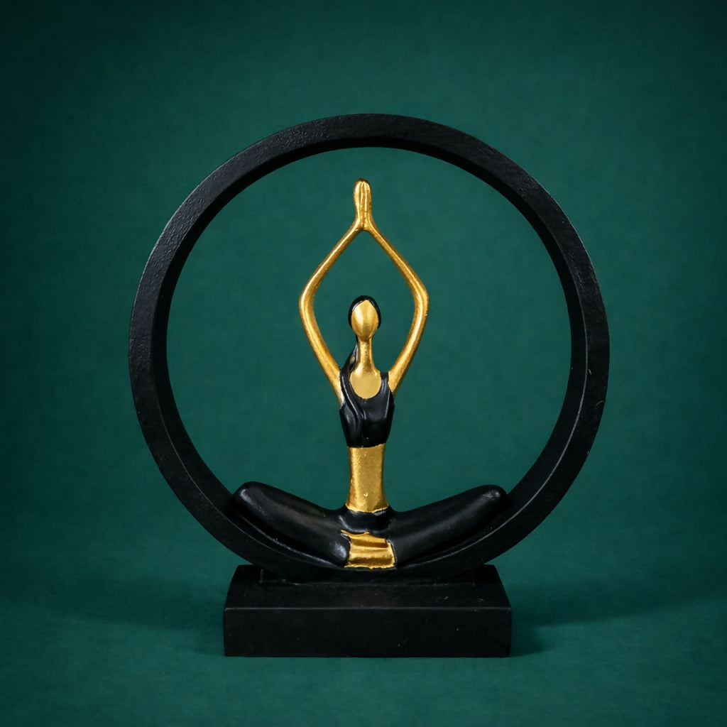 Close-up of elegant black gold yoga pose figurine in circular frame