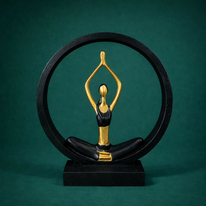Close-up of elegant black gold yoga pose figurine in circular frame