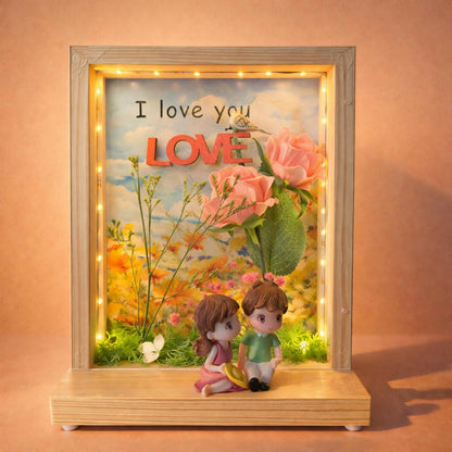 Close-up of couple figurines and floral backdrop on LED photo frame