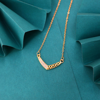 Close-up of pendant on gold plated V-shape lattice necklace with crystal detailing