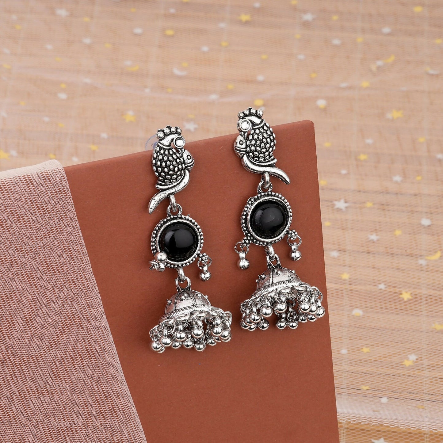 Oxidized jhumka earrings with black stone and intricate owl design, front view