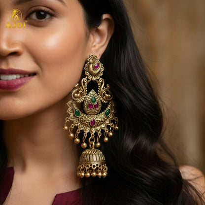 Side angle of gold plated peacock jhumka earrings showing intricate design