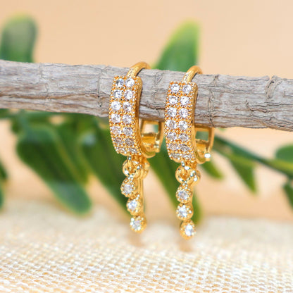 Gold plated peacock dangle huggie hoop earring adorned with sparkling CZ stones