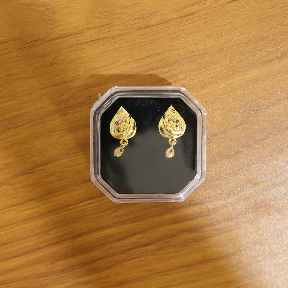 Close-up of traditional gold plated earrings showcasing craftsmanship