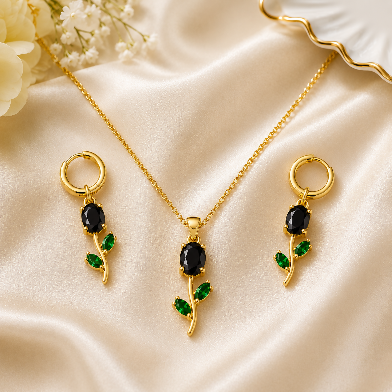 Close-up of the black oval stone pendant and green leaf crystal detailing.