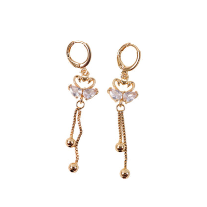 Stylish gold-tone swan dangle earrings with sparkling crystal wings and heart design