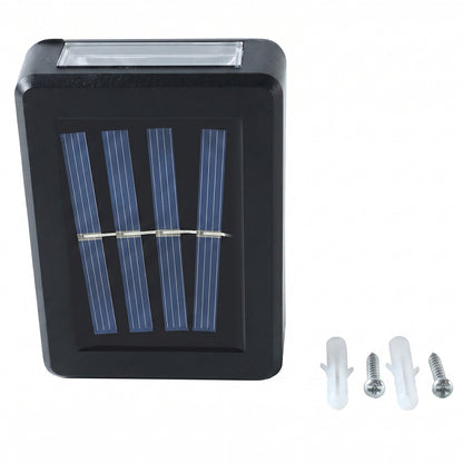 A black solar LED wall light with a blue solar panel is shown with two white wall plugs and two silver screws on a white