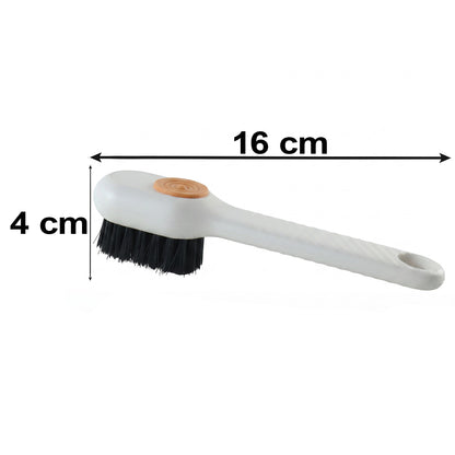 A white scrubbing brush with black bristles and an orange button is displayed with dimensions of 16 cm by 4 cm.