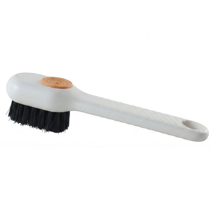 A white scrubbing brush with black bristles and an orange button is shown on a plain white background.
