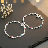 Intricate leaf/floral patterns featuring vibrant red, navy blue, and black enamel