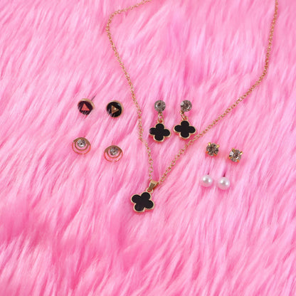 Close-up of black clover pendant showcasing gold plating and design