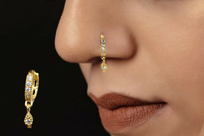 Close-up of gold plated dangle nose ring featuring sparkling white CZ stones and teardrop charm