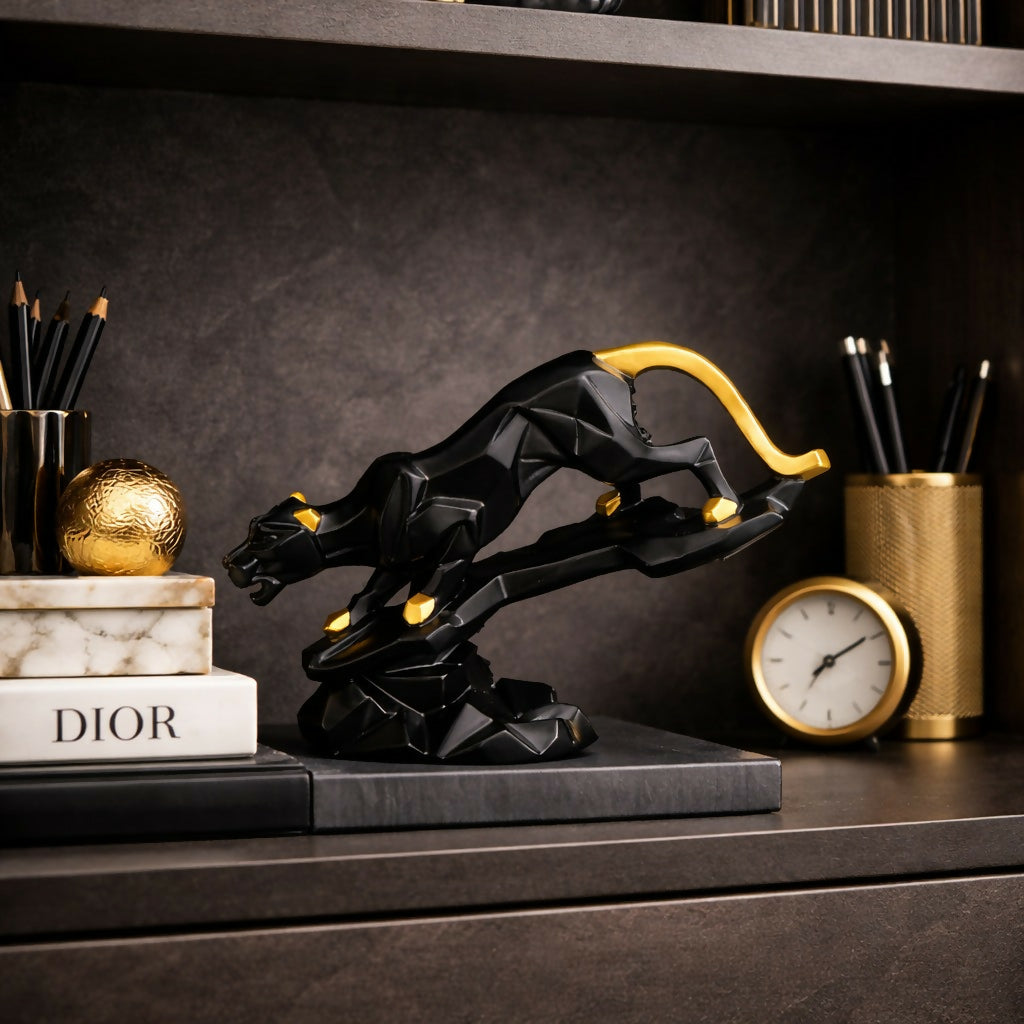 Modern leaping panther sculpture with black and gold finish